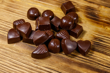 Tasty chocolate candies on wooden table