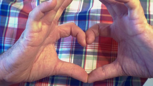 young man making gest hands in heart shape