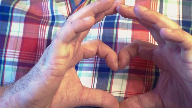 young man making gest hands in heart shape