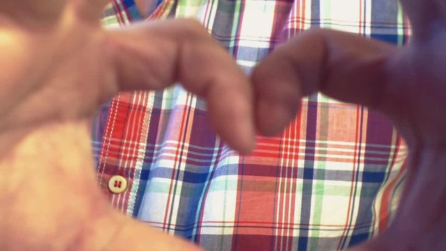 young man making gest hands in heart shape