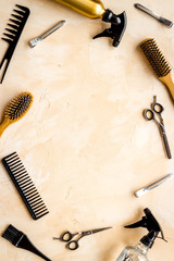 Hairdressing mockup - with brush, spray and sciccors - on beige background top-down frame copy space