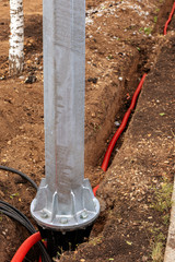 electric cable laying in underground trench. fiber optic cable for fast internet. Metal support...