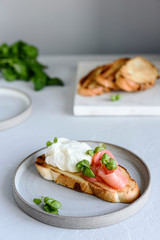 Toast with salmon, poached egg and basil. Morning and Breakfast. Healthy nutrition. Selective focus