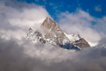 Cloud covered holy peaks of Kinner kailash Mountains of Himalaya seen from Kalpa Himachal Pradesh India