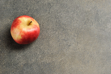 red Apple on a gray background - top view