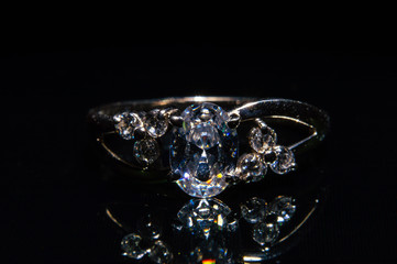 Silver ring with stones on a black background