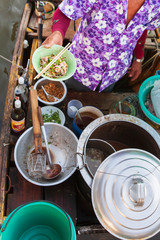 Thai vendor selling noodles on the boat.