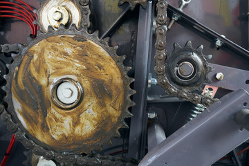 The drive chain and sprockets coated with lubricant.