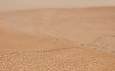 Wave On Sandy Beach. Background. Splash of waves on the sandy beach. foam, surf, waves.