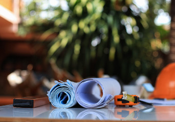 Desk of Architectural working project in construction site,With drawing equipment concept.