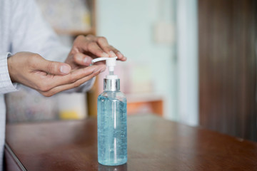 close up adult man pressing on sanitizer bottle to washing and rubbing hand to cleaning for protect virus and prevent coronavirus (MERS-n COV)  and bacteria concept