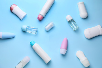 Different deodorants on color background