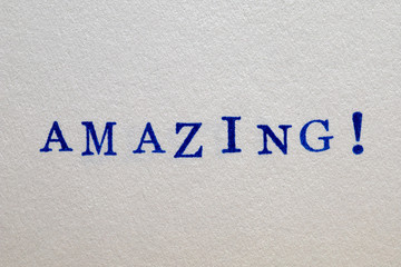 a amazing word stamped on a piece of paper.