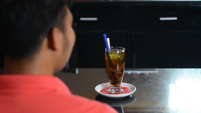 Person being served ice cold beverage at cafe restaurant by waitress, rack focus