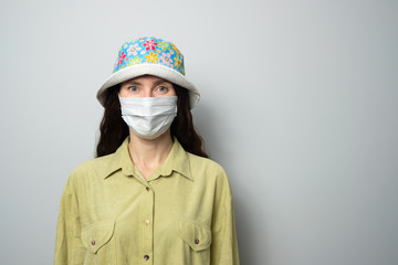 positive girl in medical mask and panama