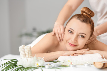 Fototapeta na wymiar Beautiful woman receiving massage in spa salon