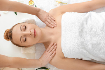 Fototapeta na wymiar Beautiful woman receiving massage in spa salon