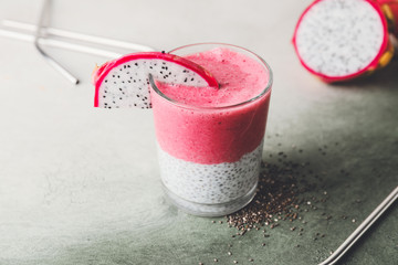 Glass of dragon fruit smoothie on color background