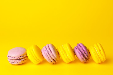 Tasty macarons on color background