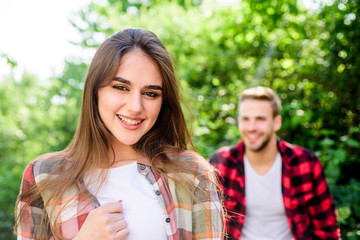 Obraz premium Being together. couple in love. first meet of couple outdoor. Relationship. happy valentines day. summer camping in forest. family weekend. romantic date. girl in selective focus with guy in park