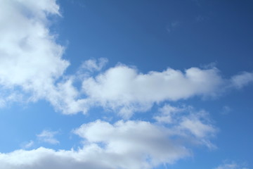 White clouds on a blue sky. Background for text and design