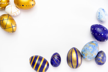 Happy Easter. Frame for text made of easter eggs trendy colored classic blue, white and golden on white. Minimal style, top view, flatlay, copy space