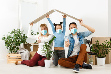 family in protective masks quarantined. Normal life with coronavirus. Lifestyle COVID-19....