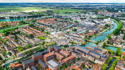 Aerial drone view of Delft town cityscape from above, typical Dutch city skyline with canals and houses, Holland, Netherlands