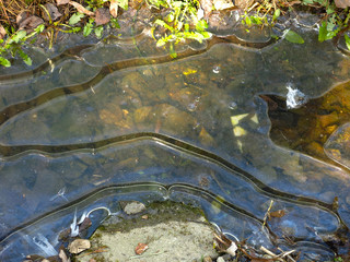 beautiful shaped ice with streaks in a frozen ditch