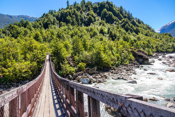 Wooden bridge across river Murta, landscape with beautiful mountains view, Patagonia, Chile, South America