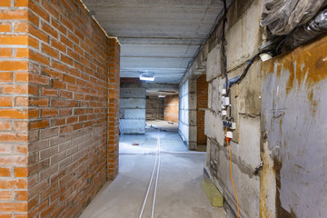 Concrete construction of basement of large building. Ground floor Inside the modern construction site in a mix of fluorescent and natural lights. Contemporary structure under construction with concret