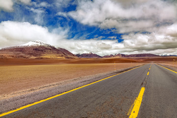 Road in Atacama desert savanna, mountains and volcano landscape, Chile, South America