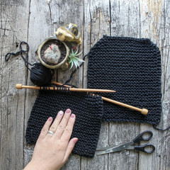 Knitting on a wooden background, a hobby, what to do at home in quarantine.