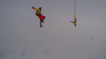 Obraz na płótnie Canvas Celebration. A man makes the first parachute jump. The first step into the abyss.