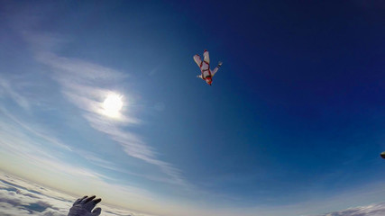 Care. Team of paratroopers. Professionals work in the air. Free fall.