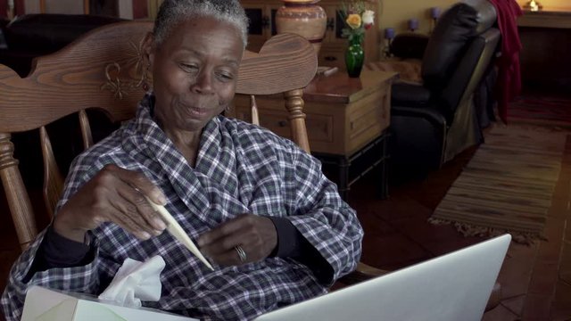 Sick Older Black Woman Finishing Her Tele Medicine Appointment In Her Home