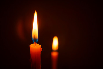 Candle lit in the dark, Candle flame at night. Lighting design for background.