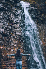 Fototapeta na wymiar woman in casual clothes looking at waterfall