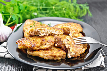 Fritters meat in black plate on board