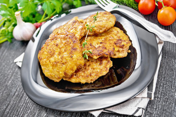 Fritters meat in plate on black wooden board
