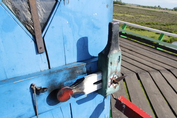 Closeup door at the top floor of a traditional Dutch Windmill in a sunny day, Zaanse Schans, Zaandam, Netherlands