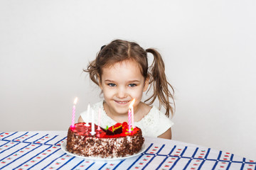 little girl and birthday cake, blows out candles, makes a wish, cake and candles, birthday gifts, family, mom and dad