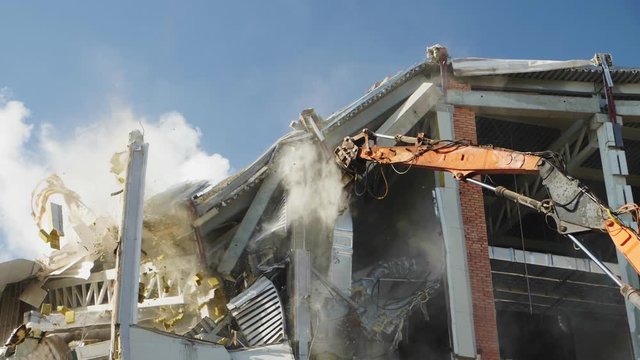 excavator cuts support to destroy hockey stadium building