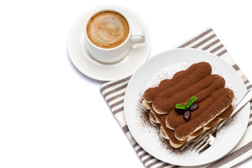 Classic tiramisu dessert on ceramic plate and cup of coffee isolated on white background with clipping path