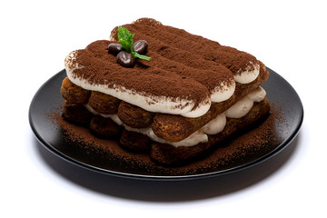 Classic tiramisu dessert on ceramic plate isolated on white background with clipping path
