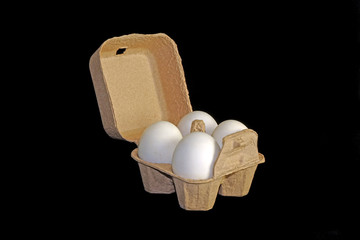 Fototapeta na wymiar Salted duck eggs in recycled paper carton packaging on black background.