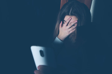 Teen girl excessively sitting at the phone at home. he is a victim of online bullying Stalker...