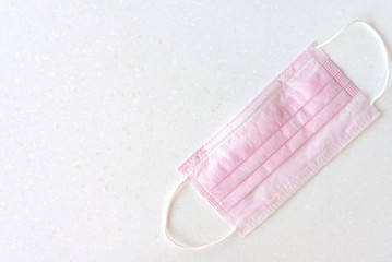 Medical mask with rubber ear straps. Typical disposable mask to cover the mouth and nose.