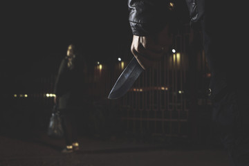 crime concepts robbery concepts a robber aimed his sharp knife at a woman to rob her valuable things