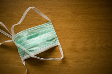 Close up medical face mask on wooden table background